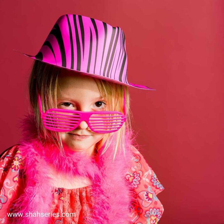 little girl wears pink dress and pink glasses with cap