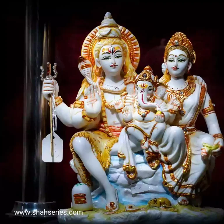 Lord Shiva and Goddess Parvati. It is an indoor sculpture, possibly located in a temple or shrine.