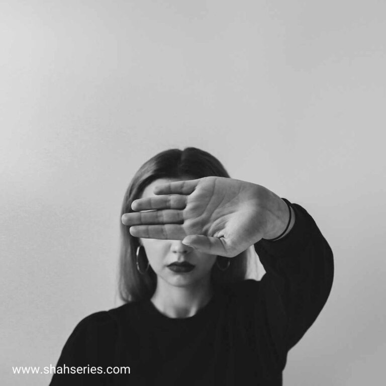 girl with black shirt cover her face with hand