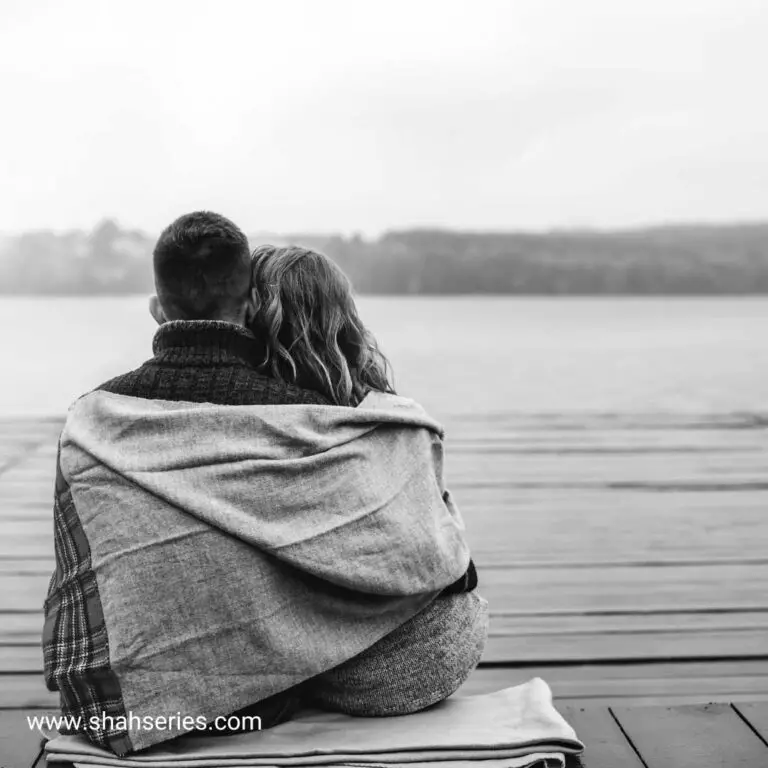 black n white background image in this image couple sitting close with each other